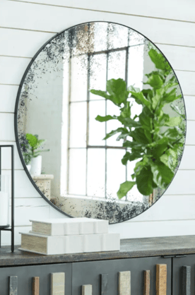 A distressed, antiqued-black mirror puts a dramatic spin on contemporary décor. Hang it opposite a window to visually double the room and bounce more natural light across the space.