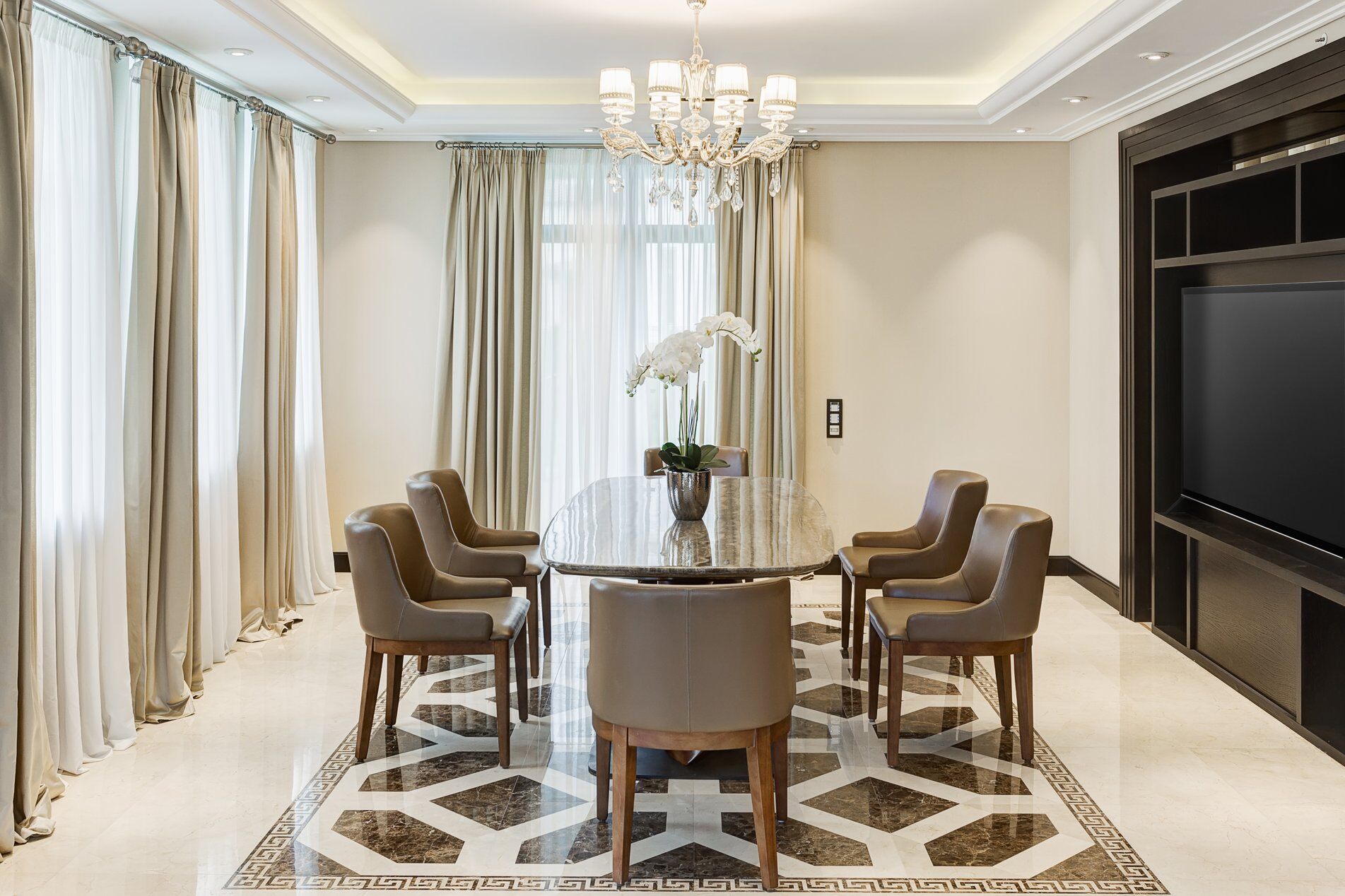 glass dining room table in room with TV