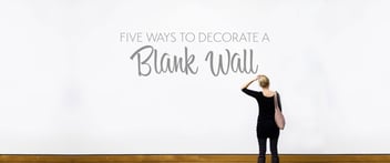 Blank wall decorated with various creative ideas including artwork, shelving, and plants