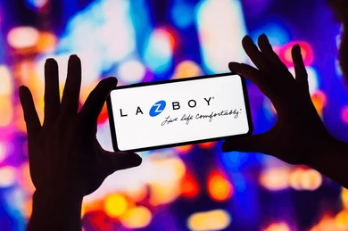 Hands holding a cell phone with La-Z-Boy logo showing