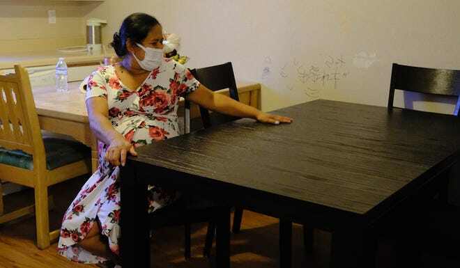 Arelis López Guzman runs her hand over her new kitchen table from Furniture Mall of Texas. 